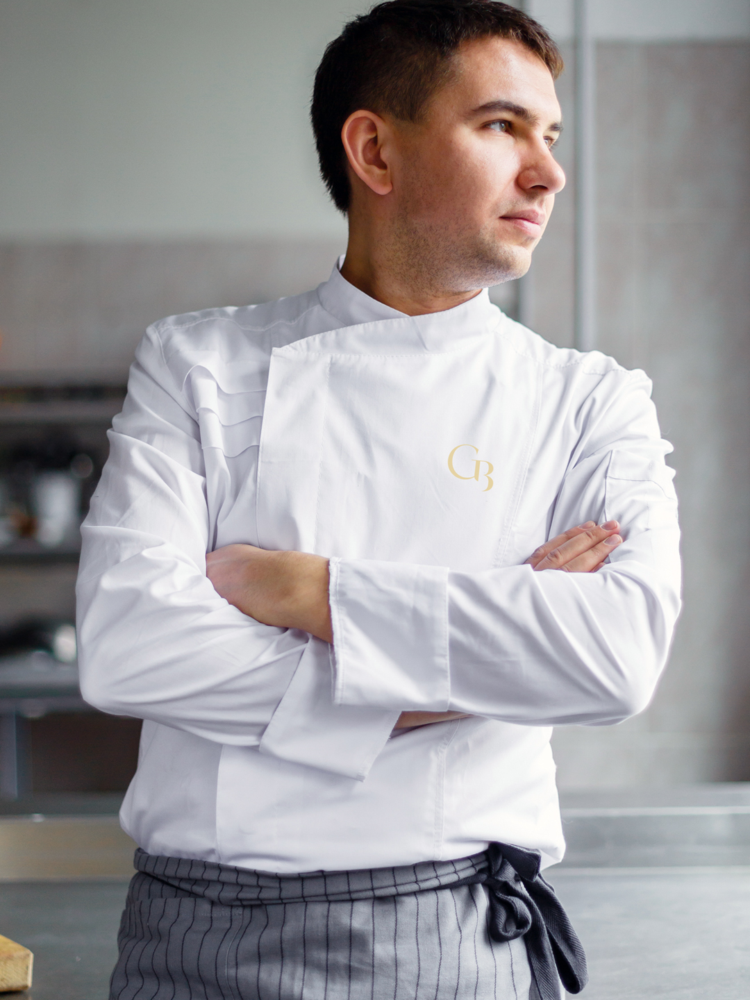 A chef wearing chef whites featuring the Chez Burton brand mark design.