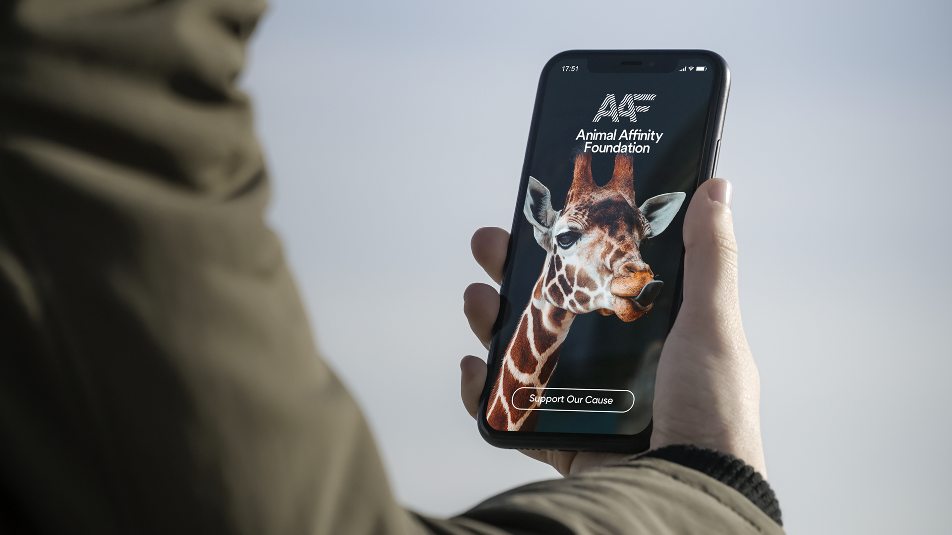 Animal Affinity brand design over a giraffe backdrop on a mobile display.