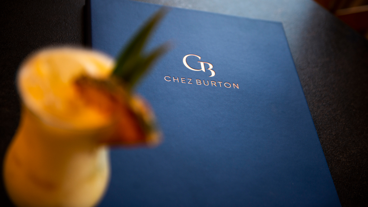 The Chez Burton menu featuring an embossed gold logo.
