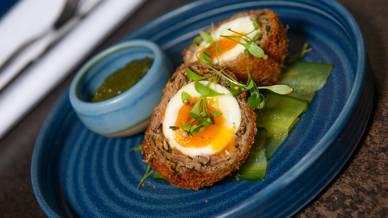 Soft-boiled lamb Scotch egg with homemade mint sauce.