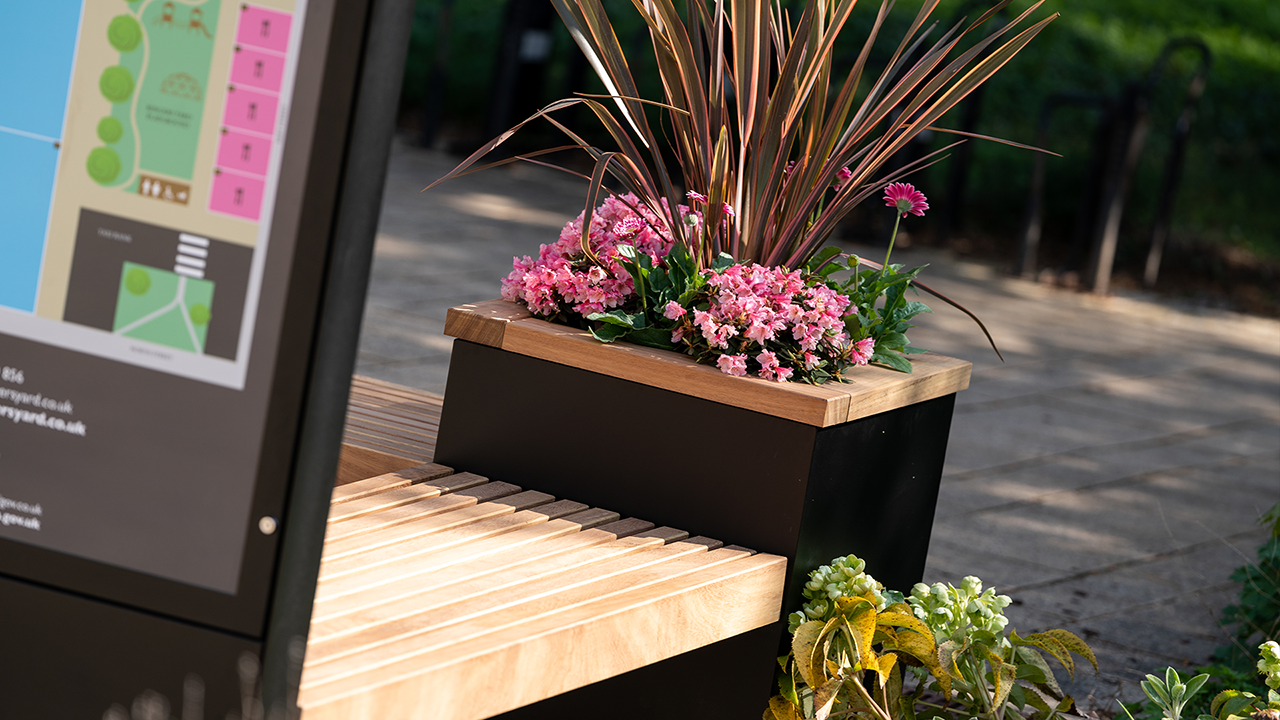 Citi System's street furniture planter containing pink flowers.