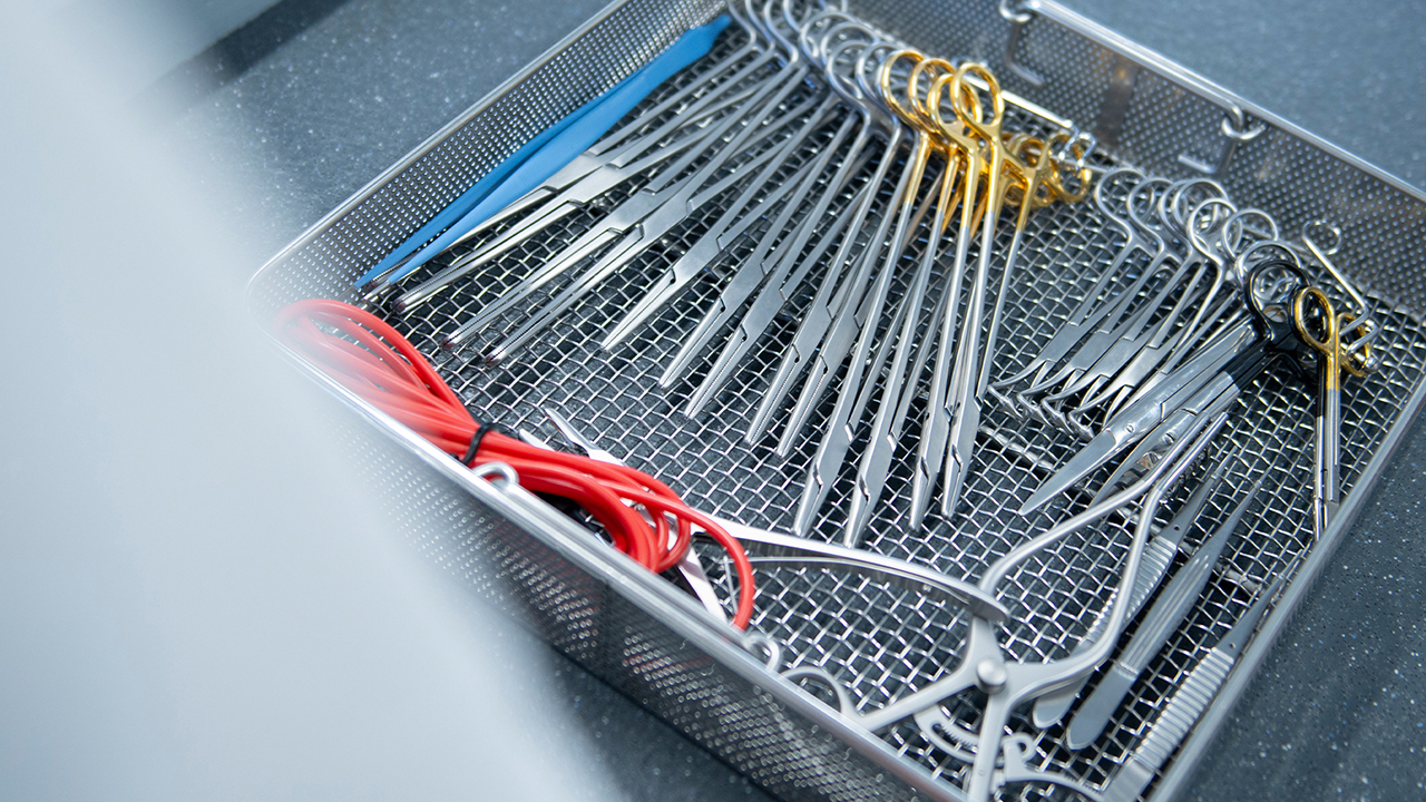 A tray of clean surgical steel instruments.