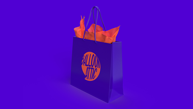 A purple gift bag featuring the Balloon Attic final brand design.