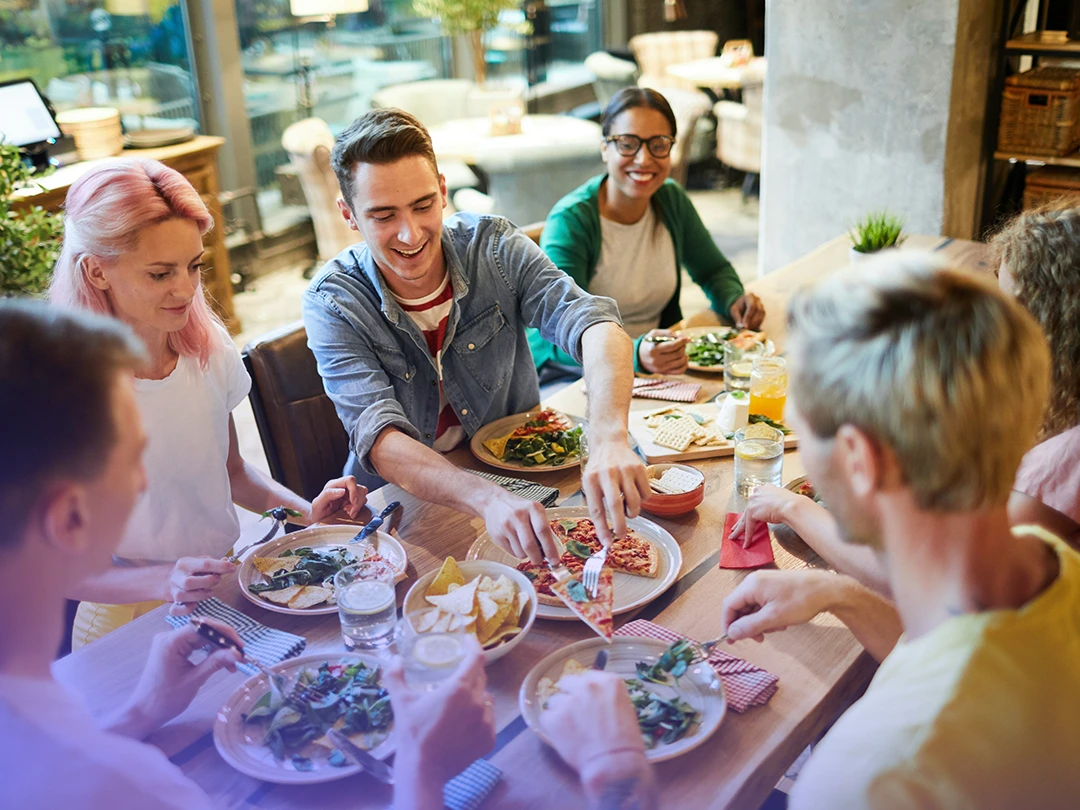 A Group Of Friends Sharing Food in a Casual Restaurant.